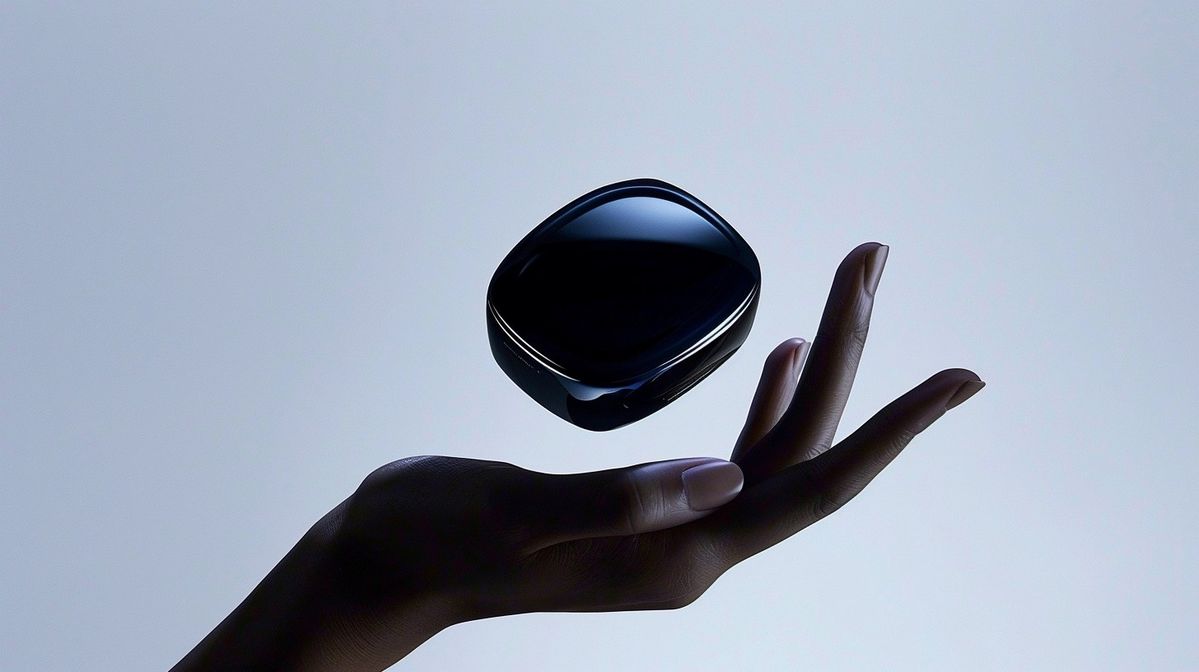 A hand under a floating black case